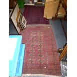 A small prayer rug, probably Afghan, woven mainly in navy and red, and a Turkoman rug with two