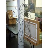 A humorous coat stand in metal styled as a floral body on twig supports TO BID ON THIS LOT AND FOR