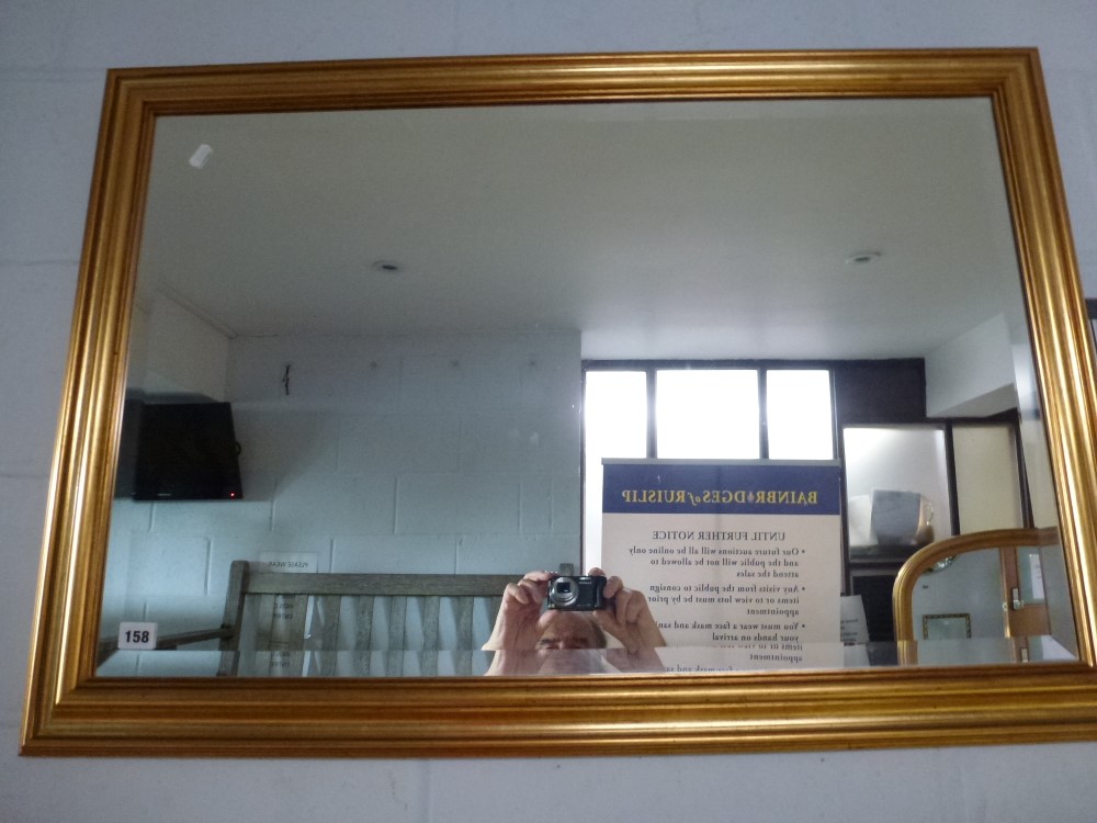 A rectangular wall mirror, the bevelled glass within a stepped gilt wood frame (66 x 99 cm) TO BID