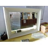 A rectangular wall mirror, the bevelled glass in a white-painted wood frame (60 x 83 cm) TO BID ON