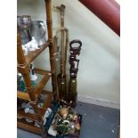 Two large brass shell cases, four wooden walking sticks - one African carved, fishing reels, rods