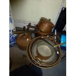 A quantity of 19th century and later copper and brass jam pans, cooking pots and sauce pans [under