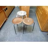 Four stylish 1950s stools each with a wooden seat and three metal legs. TO BID ON THIS LOT AND FOR