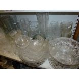 A large quantity of glassware including four decanters and stoppers, cut glass vases, fruit bowls,