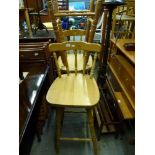 Seven pine bar stools on turned legs with spindle backs and another stool similar. WE DO NOT TAKE