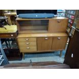 A stylish teak sideboard cum display cabinet by Nathan with glazed upper section above three drawers