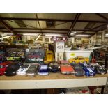 A shelf of assorted model vehicles, mainly cars, including Burago, Maisto, Saiko, Polistil and