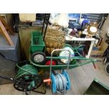 An Aemmerlin lawnmower, two garden hoses on reels plus spare hose, a sack barrow, a garden trolley