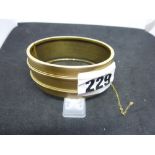 A Victorian gold hinged bangle, tests as 15 ct, interior inscribed and dated 1887, 27 gm WE DO NOT