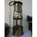A brass miner's lamp, the applied plate stamped The Protector Lamp & Lighting Co., numbered 36604 [