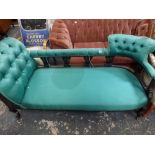 A Victorian chaise longue with a moulded and pierced ebonized frame on cabriole legs upholstered