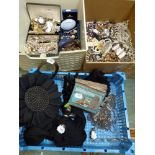 Two boxes and a blue tray containing a large quantity of highly decorative costume jewellery,