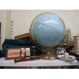 Two shelves of mixed items including a Scan-Globe Denmark table globe, a vintage desk calendar,