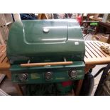 A Victoria 359BP446 three burner gas BBQ with wooden trolley [by back door] WE DO NOT TAKE CREDIT