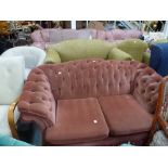 A pretty and traditional two-seater settee in buttoned pink Dralon with a deep and fancy frieze.