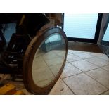 A 1930s oval oak framed mirror with beadwork decoration WE DO NOT TAKE CREDIT CARDS OR CASH. STORAGE