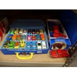 A collection of die-cast model vehicles in a Matchbox carrying case, some Matchbox cars but many