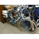 A pair of vintage bicycles one for a man the other for a woman by Motoconfort with saddle bags and