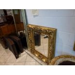 A very ornate heavy square gilt framed bevel-edge mirror decorated with flowers and leaves WE DO NOT