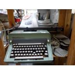 A Remington International Typewriter and a cased Olympia Typewriter. [pine shelves next to s23] WE