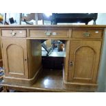 An oak pedestal desk circa 1900 with original leather top above three frieze drawers and twin