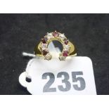 An Edwardian horseshoe ring in 18 ct gold, set with rubies and diamonds, Cheser 1902, 4.9 gm WE DO