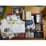 A wooden box containing three amateur stamp albums of world stamps and a small collection of First