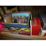 A small box of 12 in records mainly rock and pop including The Beatles: Help, Hard Day's Night,