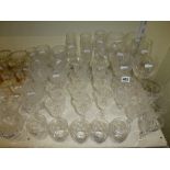 Two shelves of glassware including 1930s champagne saucers, further champagne flutes, wine
