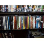 A quantity of CDs including Queen and Disney and a quantity of DVDs including Garfield and Fight