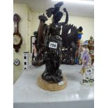 A 19th century bronze figure of a naked maiden with scaly fish by a leafy scroll, on marble base,