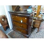 An American modern bow-fronted chest of three deep drawers and a secret frieze drawer possibly in