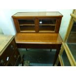 A cherry wood desk with pull-out top above a drawer beneath a glazed superstructure and a