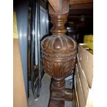 A substantial mid 20th century oak drawer-leaf dining table on bulbous and ornate carved pedestal