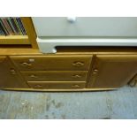 An Ercol light oak sideboard the three central drawers flanked by cupboards. WE DO NOT TAKE CREDIT