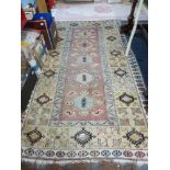 Three rugs: two in pink, one of them with keywork decoration the other in an Eastern pattern with