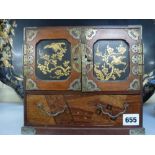 A Japanese wood marquetry and lacquer small cabinet of doors and drawers, circa 1900, containing