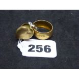 An Egyptian 18 ct gold broad ring, 5.4 gm; and a 9 ct heart locket, 2 gm WE DO NOT TAKE CREDIT CARDS