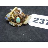 Four opal rings, comprising one in 10 ct gold of cluster design with a surround of red stones, the