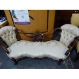 A spectacular Victorian double ended chaise longue with an exuberant carved and moulded frame, the