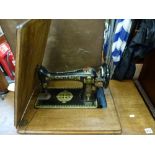 A Singer Sewing Machine in its original folding table with metal treadle base. WE DO NOT TAKE CREDIT