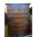 A charming George III country oak chest on chest cross-banded in mahogany, the upper section of