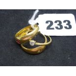 Three 18 ct gold rings comprising: one gypsy-set with a diamond between two rubies, Birmingham 1888;