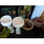 Eight planters including terracotta and a pair of white pottery planters on stands WE DO NOT TAKE