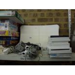A Wii console and Wii Fit with games including Super Mario, Mario Cart, Wii Fit and a quantity of
