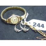 A lady's 9 ct gold wrist watch by Bentina Star, on metal bracelet; a 9 ct and sapphire bar brooch