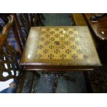 A Victorian sewing table with checkerboard top above a fitted interior and tapering base on four