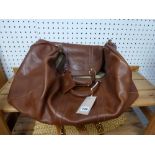 A large tan leather holdall, Mark Cross New York [upstairs shelves] WE DO NOT TAKE CREDIT CARDS OR