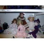 Four decorative china-headed dolls plus another. [s12] WE DO NOT TAKE CREDIT CARDS OR CASH.