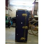 A metal-bound cabin trunk with a blue fabric cover and lock by Messman of London. WE DO NOT TAKE